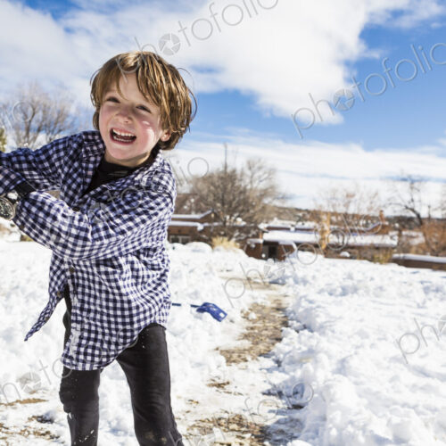 A six year old boy throwing a snowball A six year old boy throwing a snowball