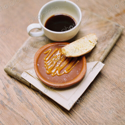 A slice of bread, honey or sweet paste, and a cup of coffee. A slice of bread, honey or sweet paste, and a cup of coffee.