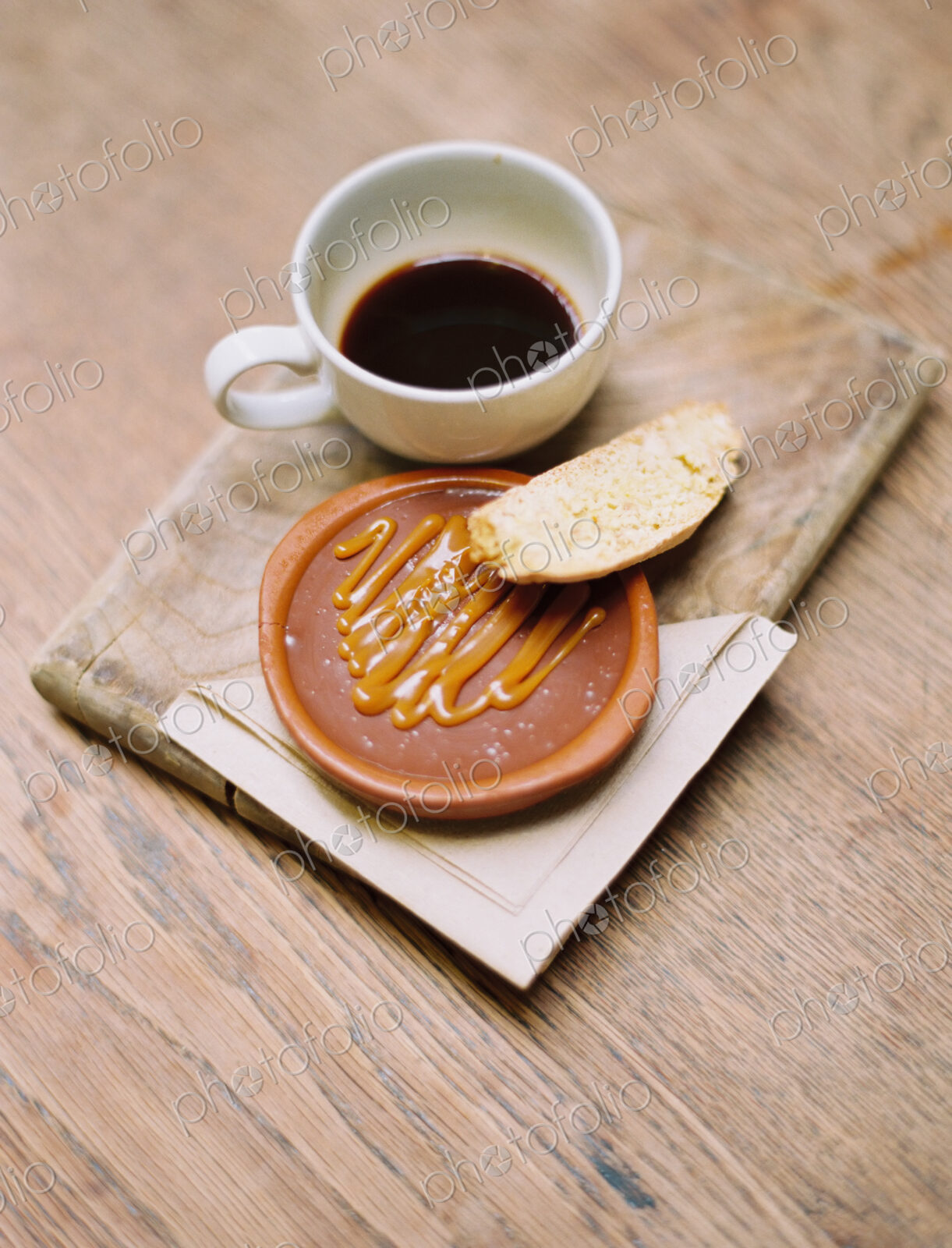 A slice of bread, honey or sweet paste, and a cup of coffee.