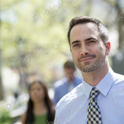 A small group of people, a businesswoman and two businessmen outdoors in the city. A small group of people, a businesswoman and two businessmen outdoors in the city.