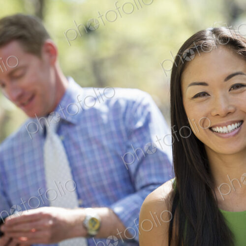 A small group of people, a businesswoman and two businessmen outdoors in the city. A small group of people, a businesswoman and two businessmen outdoors in the city.