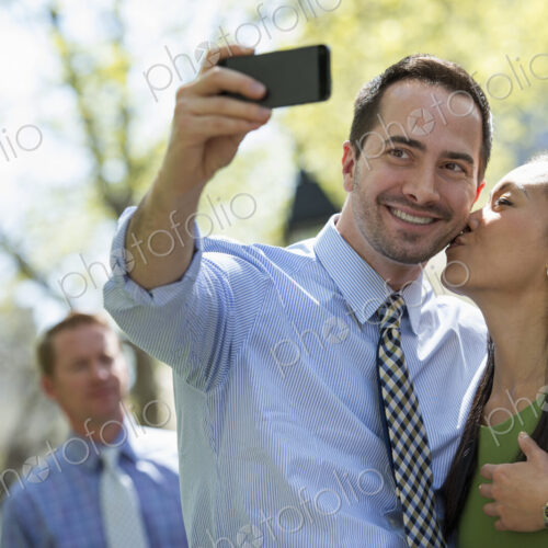 A small group of people, a businesswoman and two businessmen outdoors in the city. A small group of people, a businesswoman and two businessmen outdoors in the city.