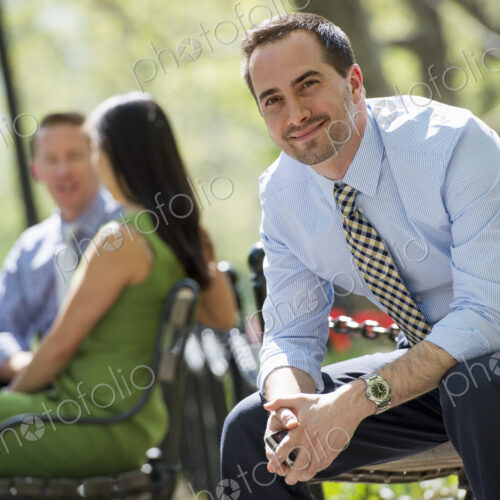 A small group of people, a businesswoman and two businessmen outdoors in the city. A small group of people, a businesswoman and two businessmen outdoors in the city.