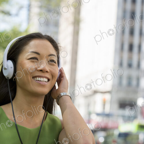 A small group of people, a businesswoman and two businessmen outdoors in the city. A small group of people, a businesswoman and two businessmen outdoors in the city.