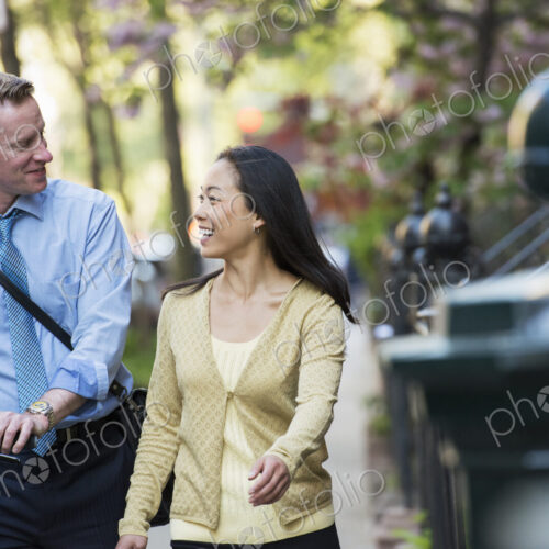 A small group of people, a businesswoman and two businessmen outdoors in the city. A small group of people, a businesswoman and two businessmen outdoors in the city.