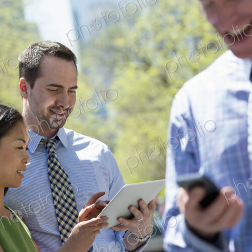A small group of people, a businesswoman and two businessmen outdoors in the city.… A small group of people, a businesswoman and two businessmen outdoors in the city.…