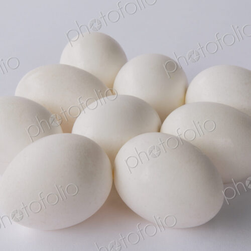 A small group or clutch of nine free range organic egg with white shells against a… A small group or clutch of nine free range organic egg with white shells against a…