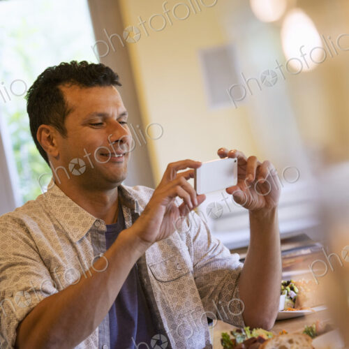 A small holding up a small smart phone.