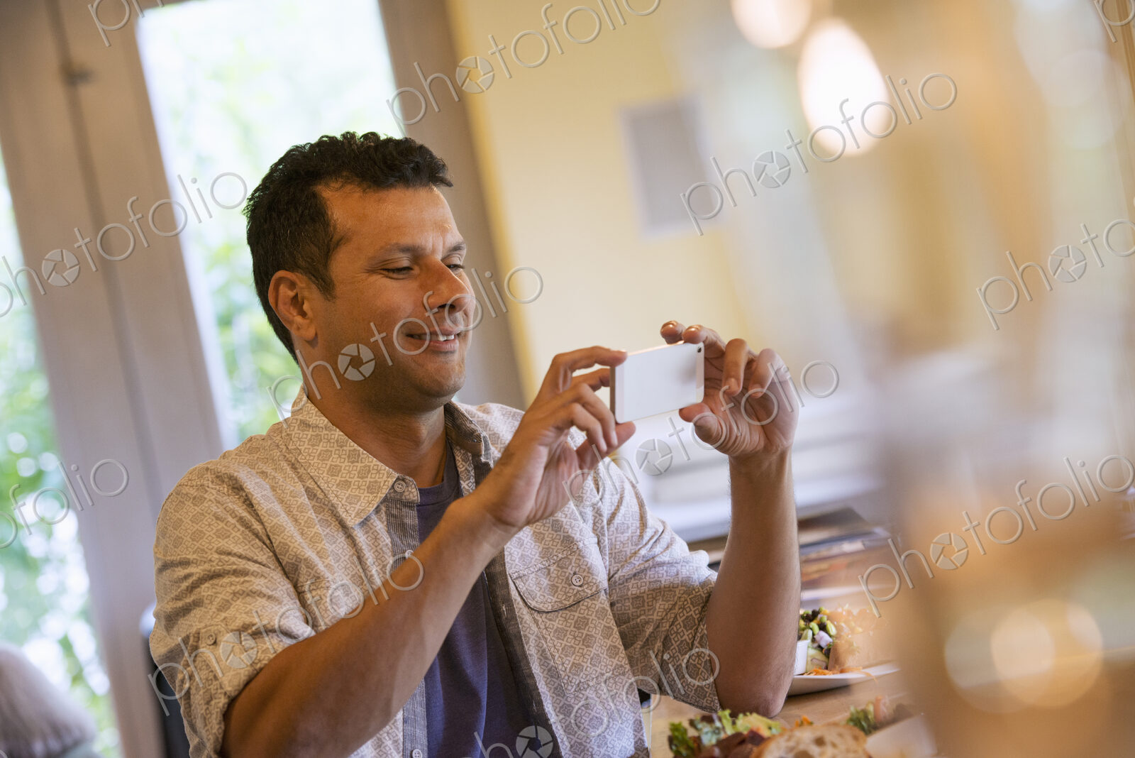 A small holding up a small smart phone.
