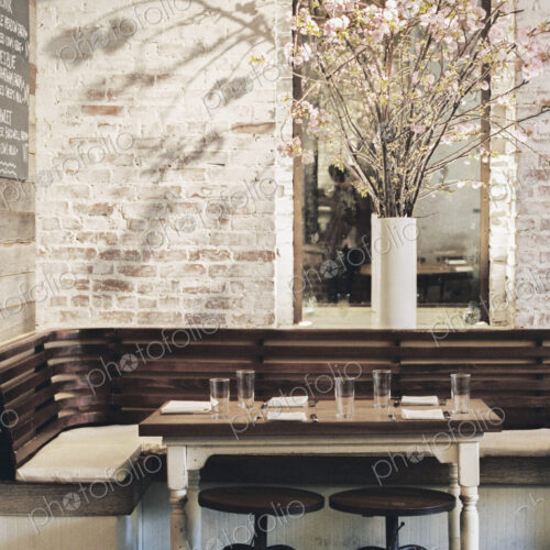 A small table with four place settings in a restaurant. A small table with four place settings in a restaurant.