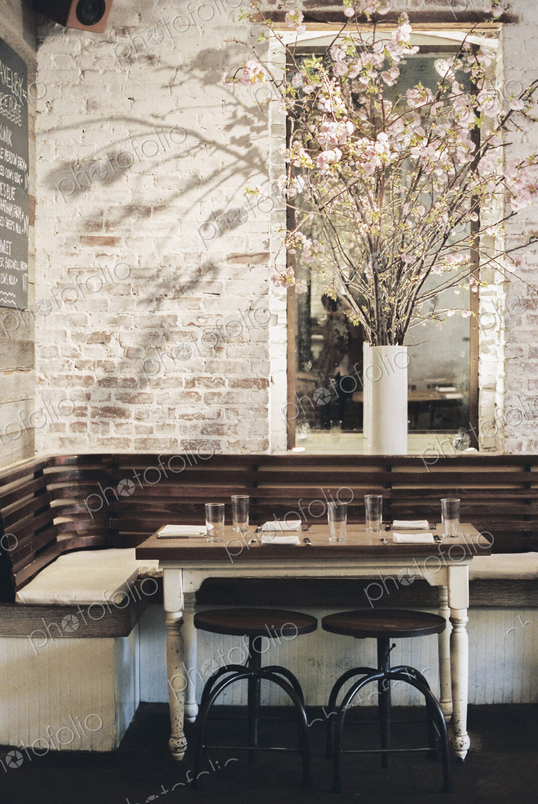 A small table with four place settings in a restaurant.