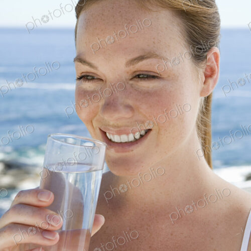A spa treatment centre. A young woman drinking a glass of water. A spa treatment centre. A young woman drinking a glass of water.