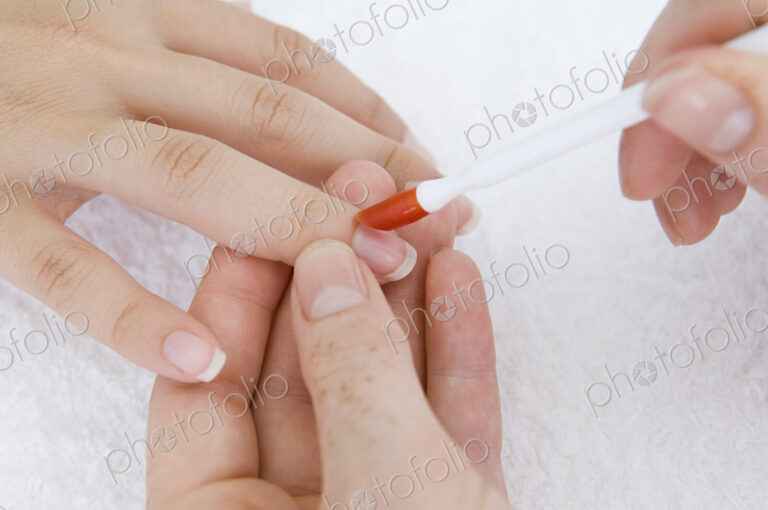 A spa treatment centre. A young woman having a manicure.