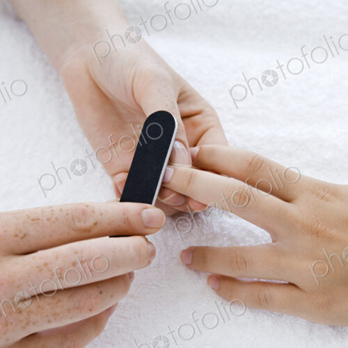 A spa treatment centre. A young woman having a manicure. A spa treatment centre. A young woman having a manicure.