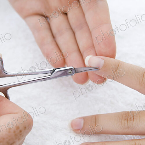 A spa treatment centre. A young woman having a manicure, having her fingernails shaped. A spa treatment centre. A young woman having a manicure, having her fingernails shaped.