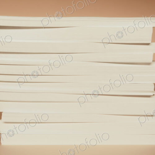 A stack of recycled white paper, paper supplies.