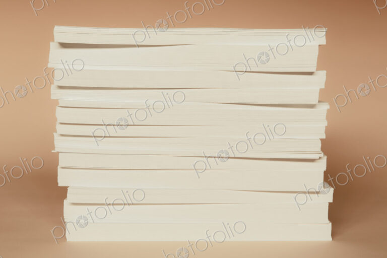 A stack of recycled white paper, paper supplies.