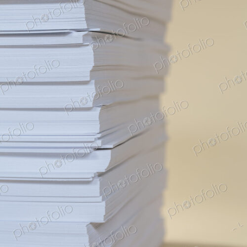 A stack of recycled white paper, paper supplies.