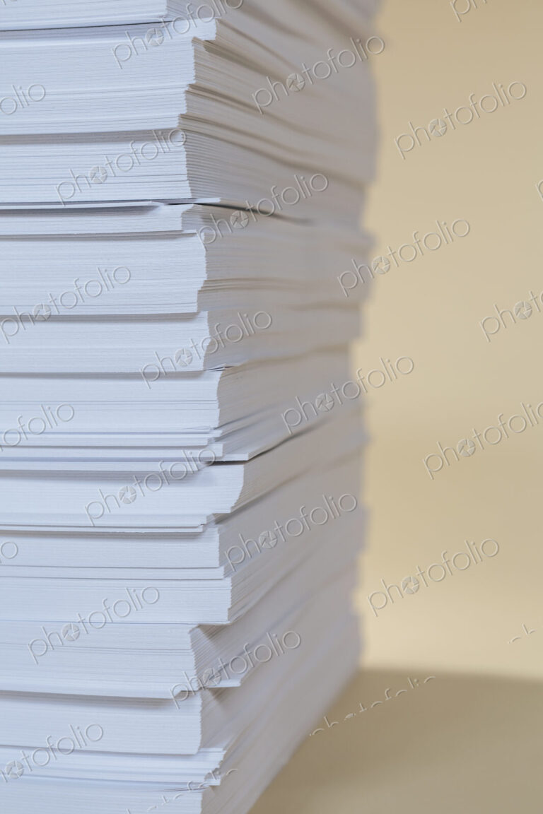 A stack of recycled white paper, paper supplies.