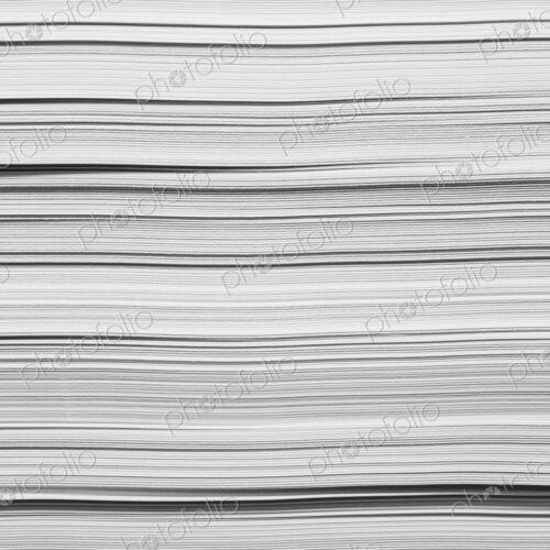 A stack of recycled white paper, paper supplies. The paper edges.