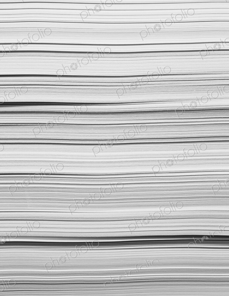 A stack of recycled white paper, paper supplies. The paper edges.