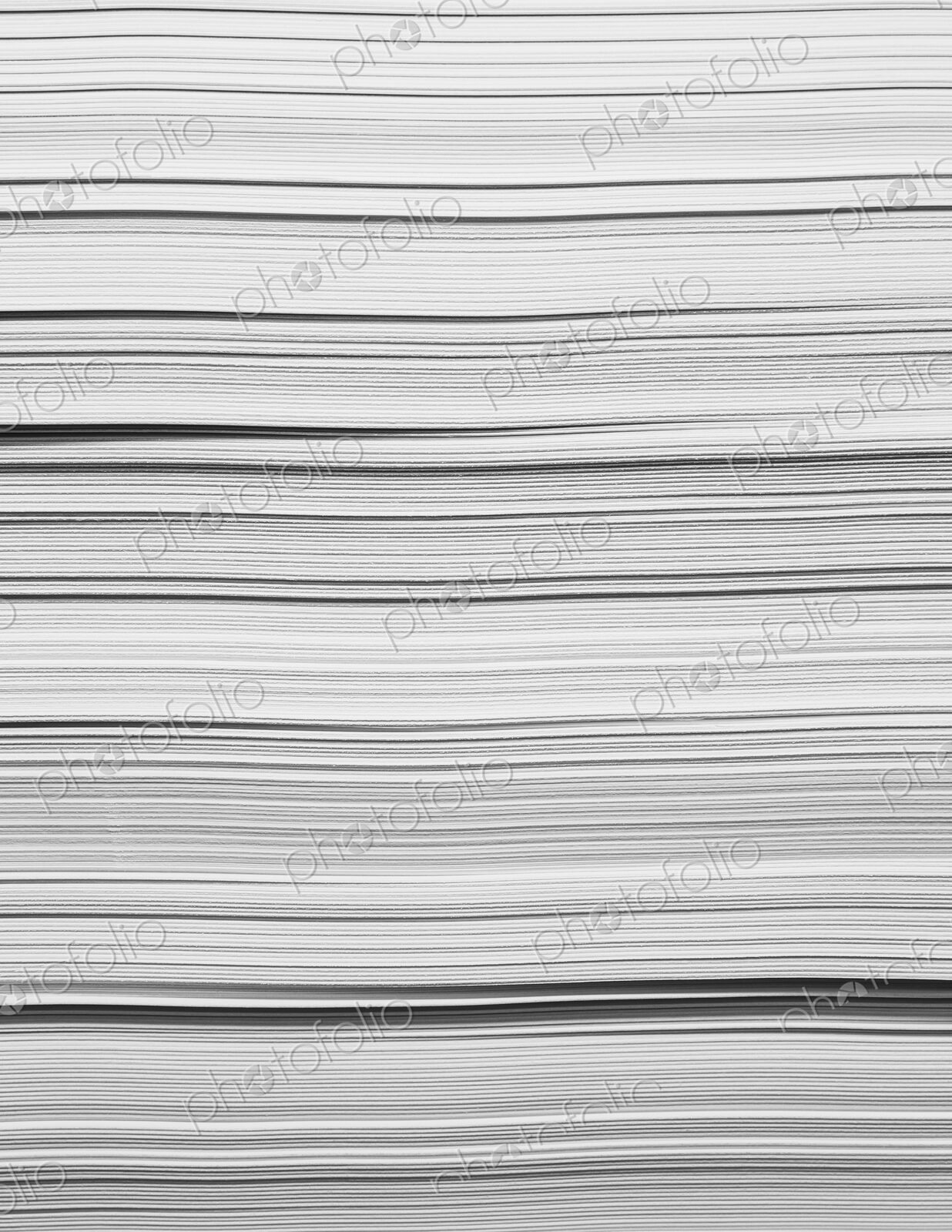 A stack of recycled white paper, paper supplies. The paper edges.