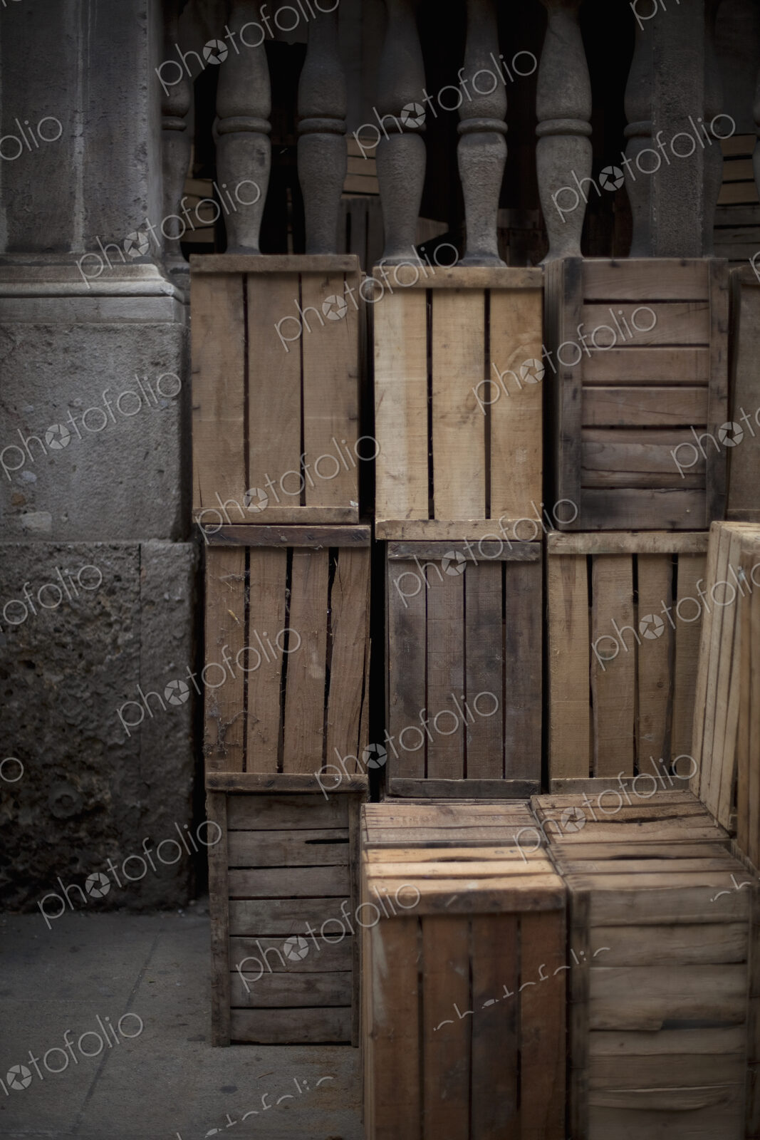 A stack of wooden crates, in the corner of a room.