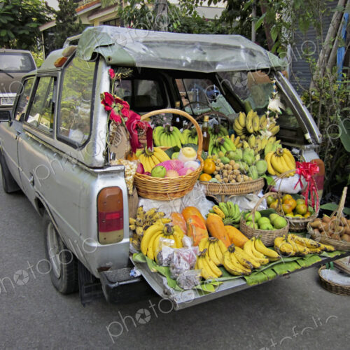 A station wagon car with the tailgate down, loaded with produce for sale, fresh… A station wagon car with the tailgate down, loaded with produce for sale, fresh…
