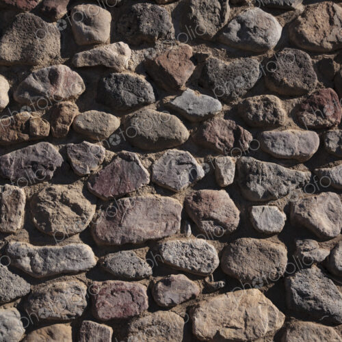 A stone wall with irregular shaped stone blocks fitted together. A stone wall with irregular shaped stone blocks fitted together.