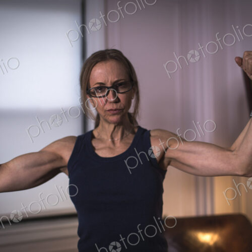 A strong woman with toned arms and clenched fists. A strong woman with toned arms and clenched fists.