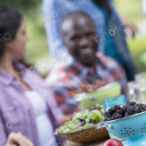 A summer party outdoors. A group of friends at a table.