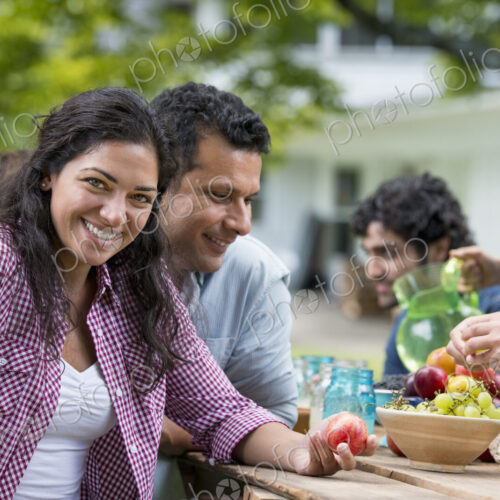 A summer party outdoors. Friends around a table.