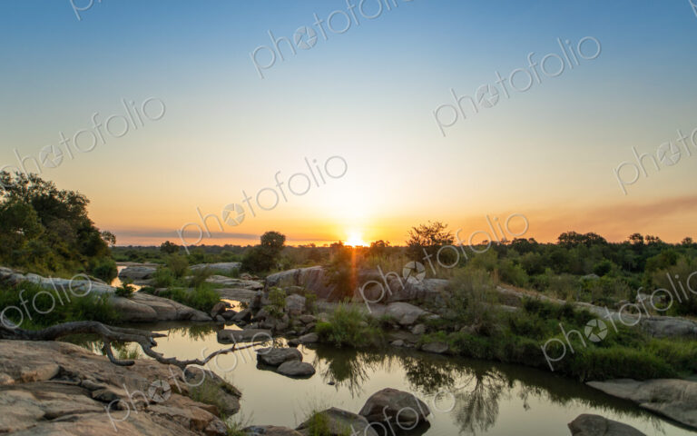 A sunset over a riverine landscape.