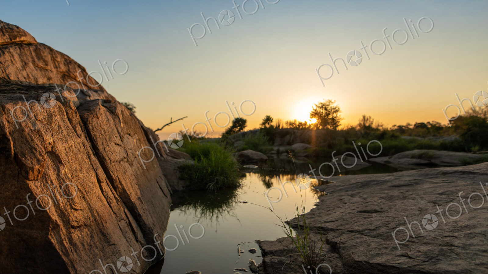A sunset over a riverine landscape.