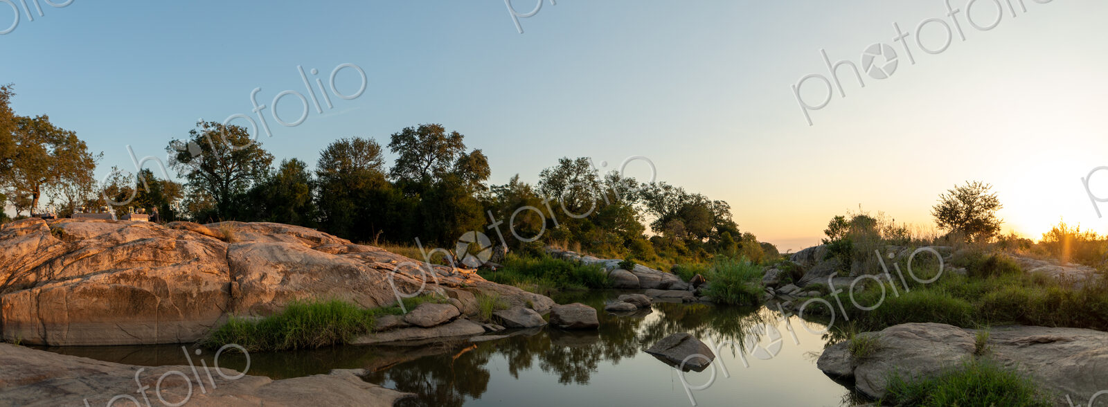 A sunset over a riverine landscape.