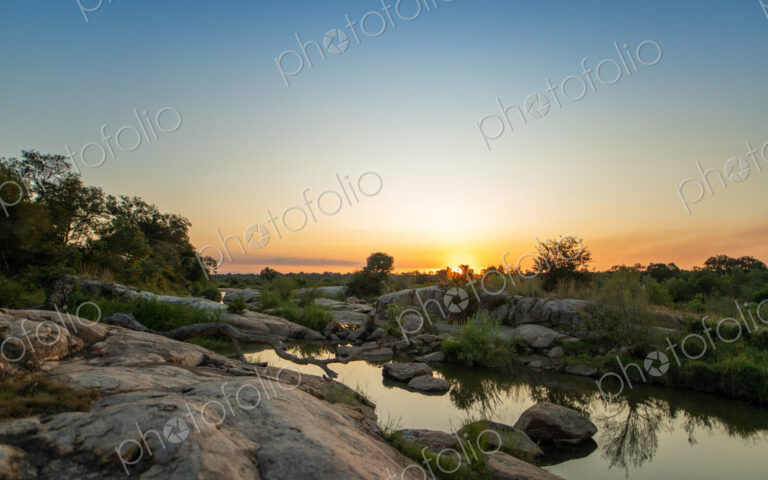 A sunset over a riverine landscape.