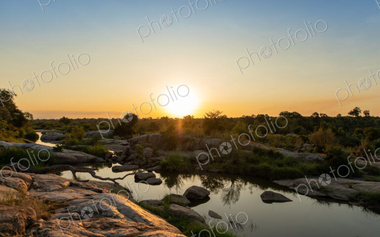 A sunset over a riverine landscape.