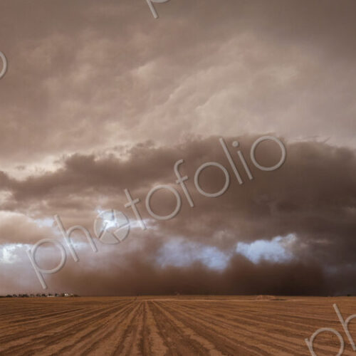 A supercell, a severe warning storm, a sky with dramatic dark clouds sitting on the…