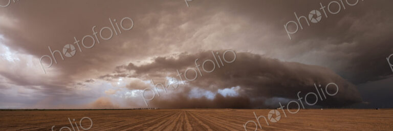 A supercell, a severe warning storm, a sky with dramatic dark clouds sitting on the…