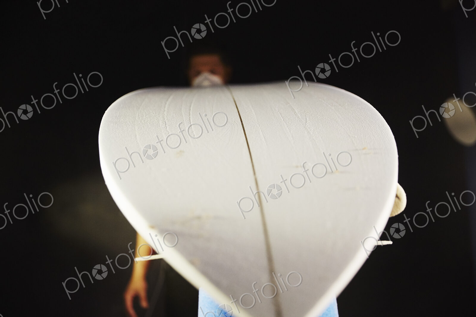 A surfboard in a workshop waiting for repair.