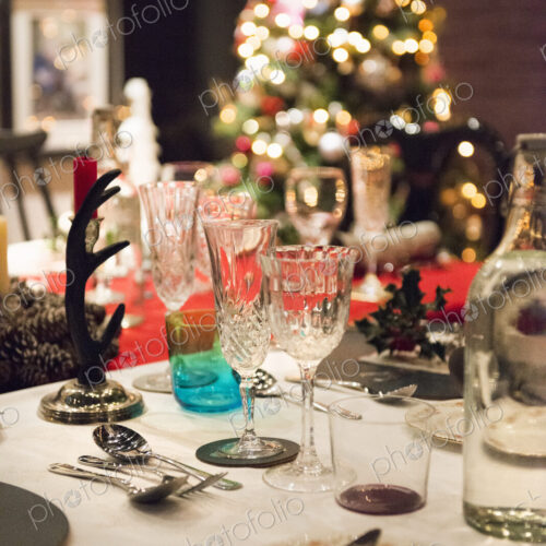 A table laid for a Christmas meal, with silver and crystal glasses