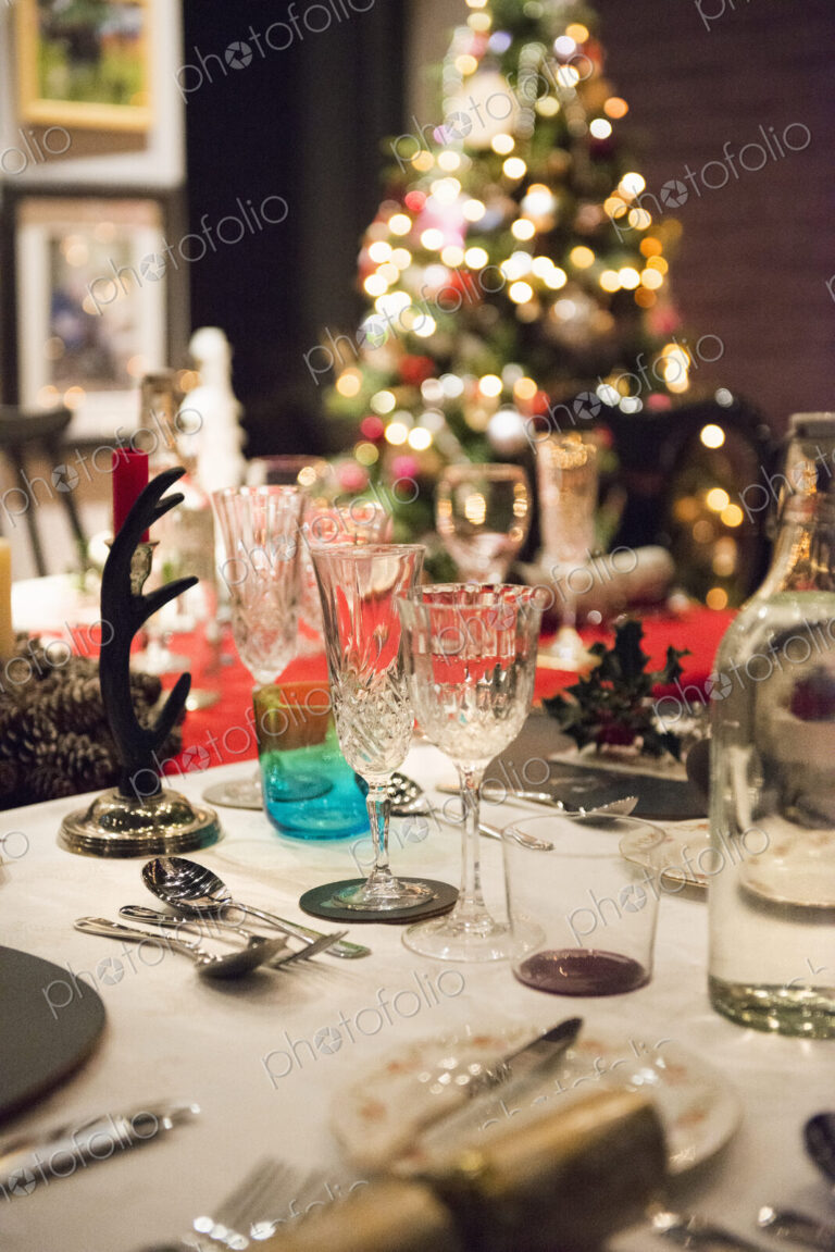 A table laid for a Christmas meal, with silver and crystal glasses