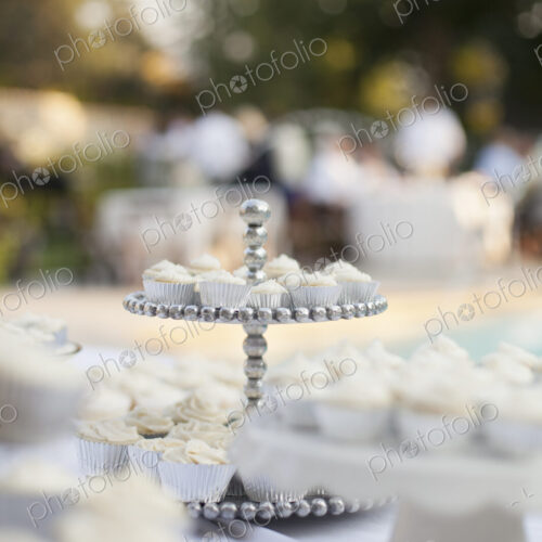 A table laid for a banquet or a wedding breakfast. White table cloth, cake stand, and… A table laid for a banquet or a wedding breakfast. White table cloth, cake stand, and…