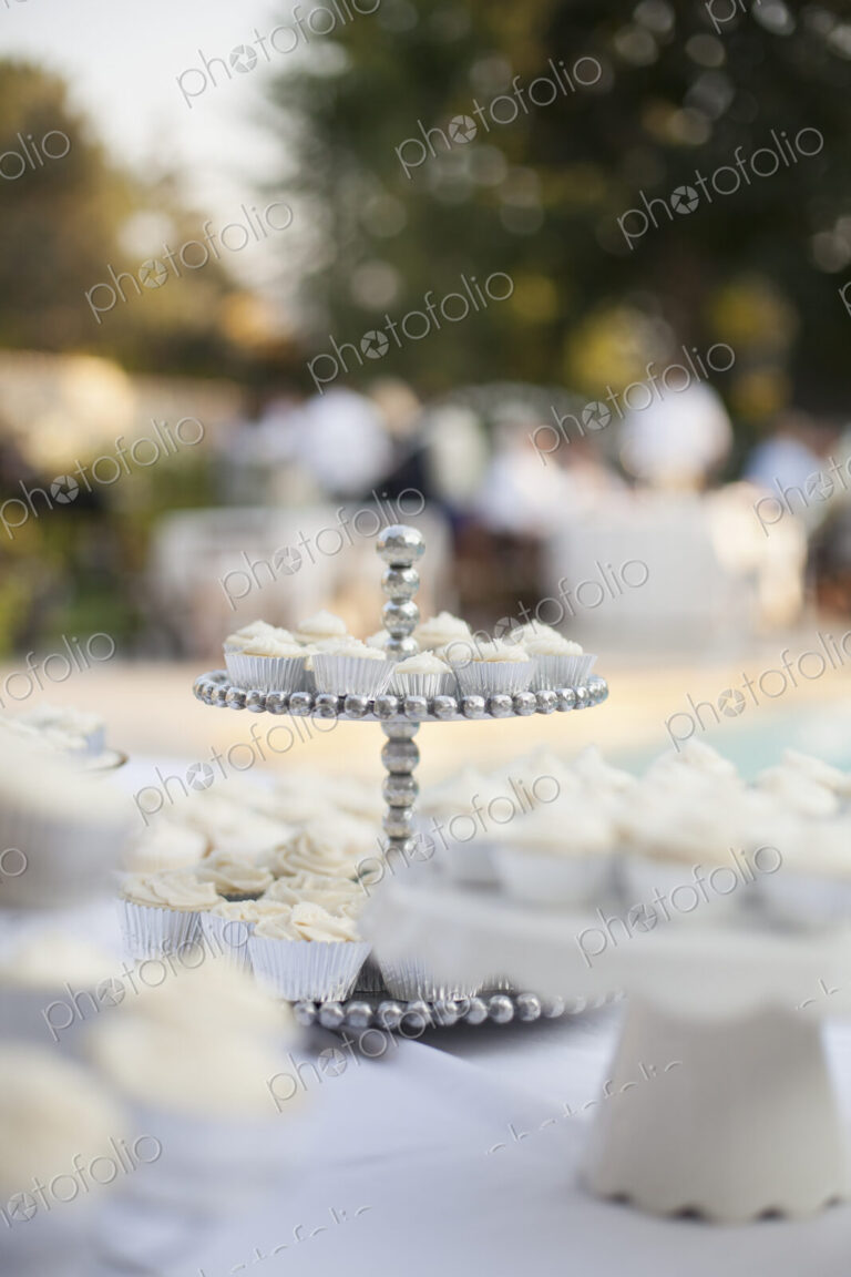 A table laid for a banquet or a wedding breakfast. White table cloth, cake stand, and…