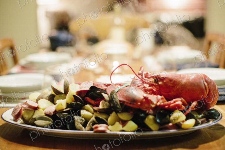 A table laid for a meal, a seafood platter with lobster and clams.