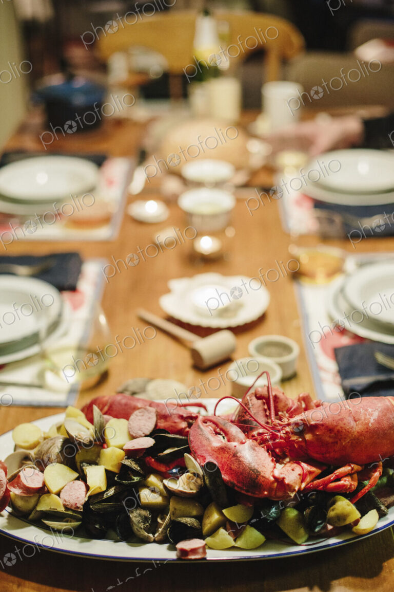 A table laid for a meal, a seafood platter with lobster and clams.