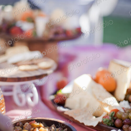 A table laid with a buffet selection of food dishes. Desserts and cheese board. A table laid with a buffet selection of food dishes. Desserts and cheese board.