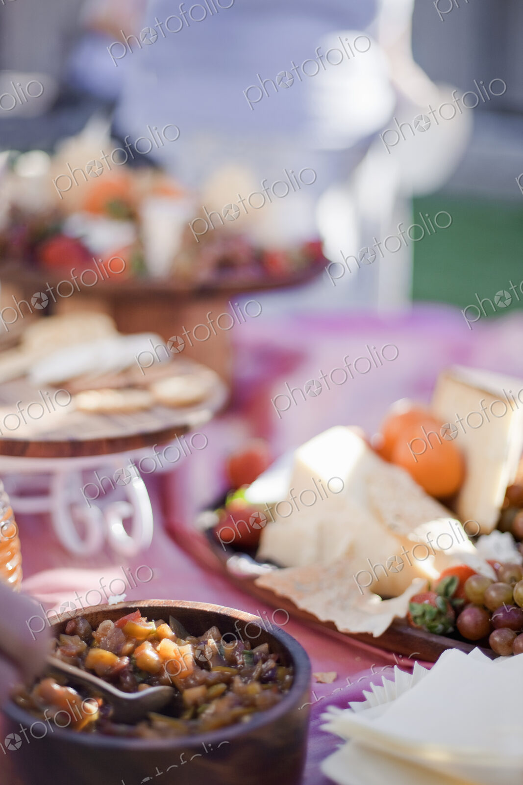 A table laid with a buffet selection of food dishes. Desserts and cheese board.