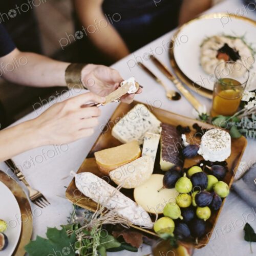 A table laid with a white cloth and place settings seen from above. An organic cheese… A table laid with a white cloth and place settings seen from above. An organic cheese…
