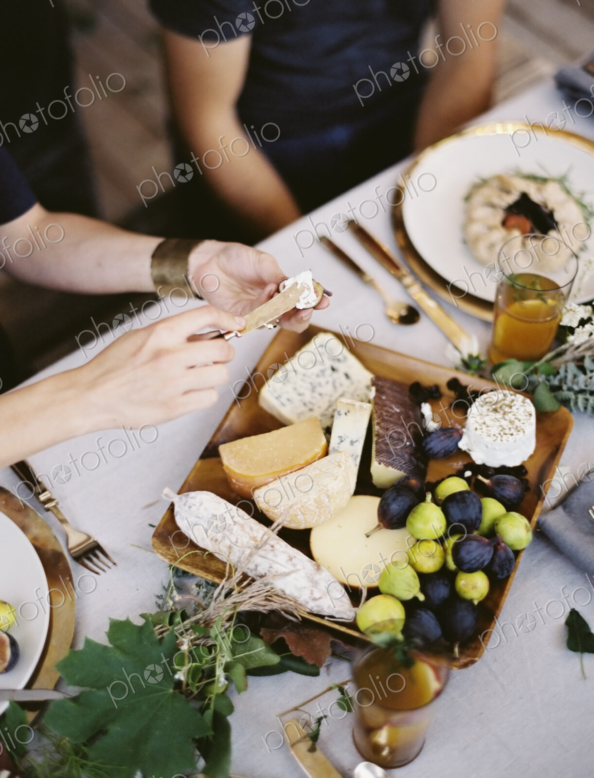 A table laid with a white cloth and place settings seen from above. An organic cheese…